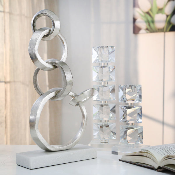 Linked Silver Rings On Marble Base image
